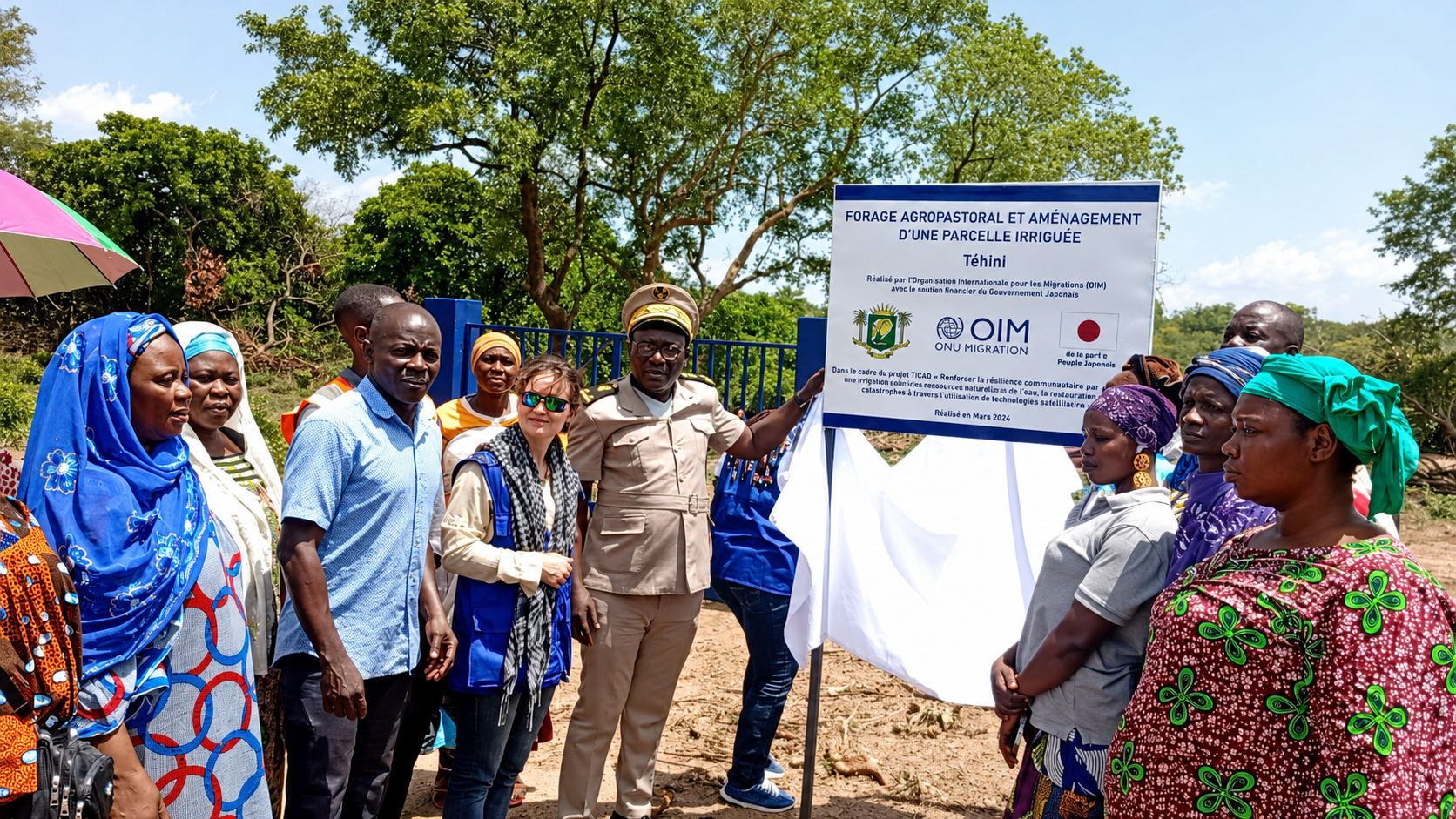 Community members at a borehole and irrigation-plot inauguration in Téhini